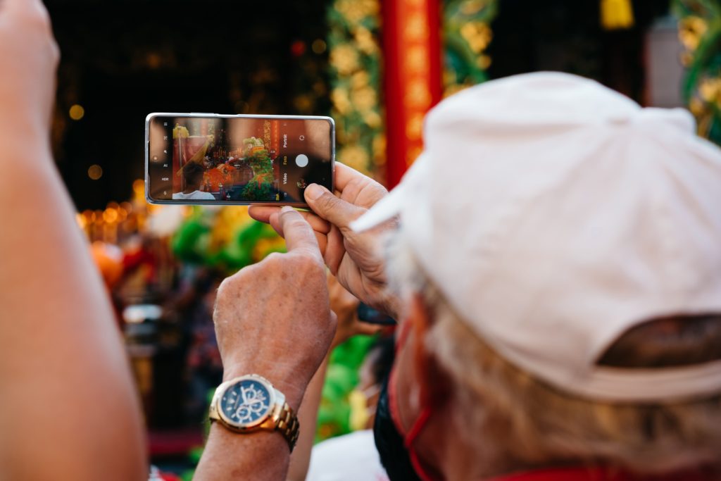 Man recording a video on mobile phone.