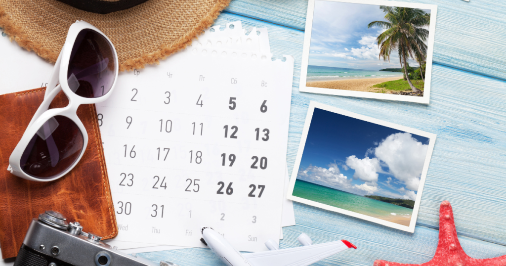 A calendar is on a table next to some vacation photos of a tropical destination as a business owner plans for their vacation time off.