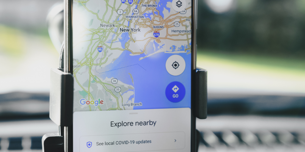 A phone is opened to Google Maps which shows what businesses are located in the area near where the person is located, this is considered local SEO.